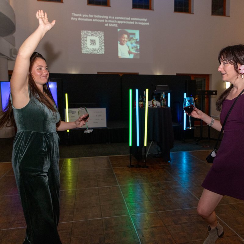 Guest dancing with an arm raised on the dance floor at a gala