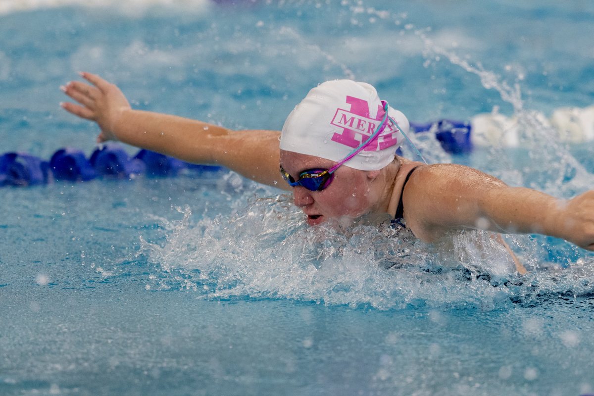 Swimmer in a pink cap powering through a butterfly stroke